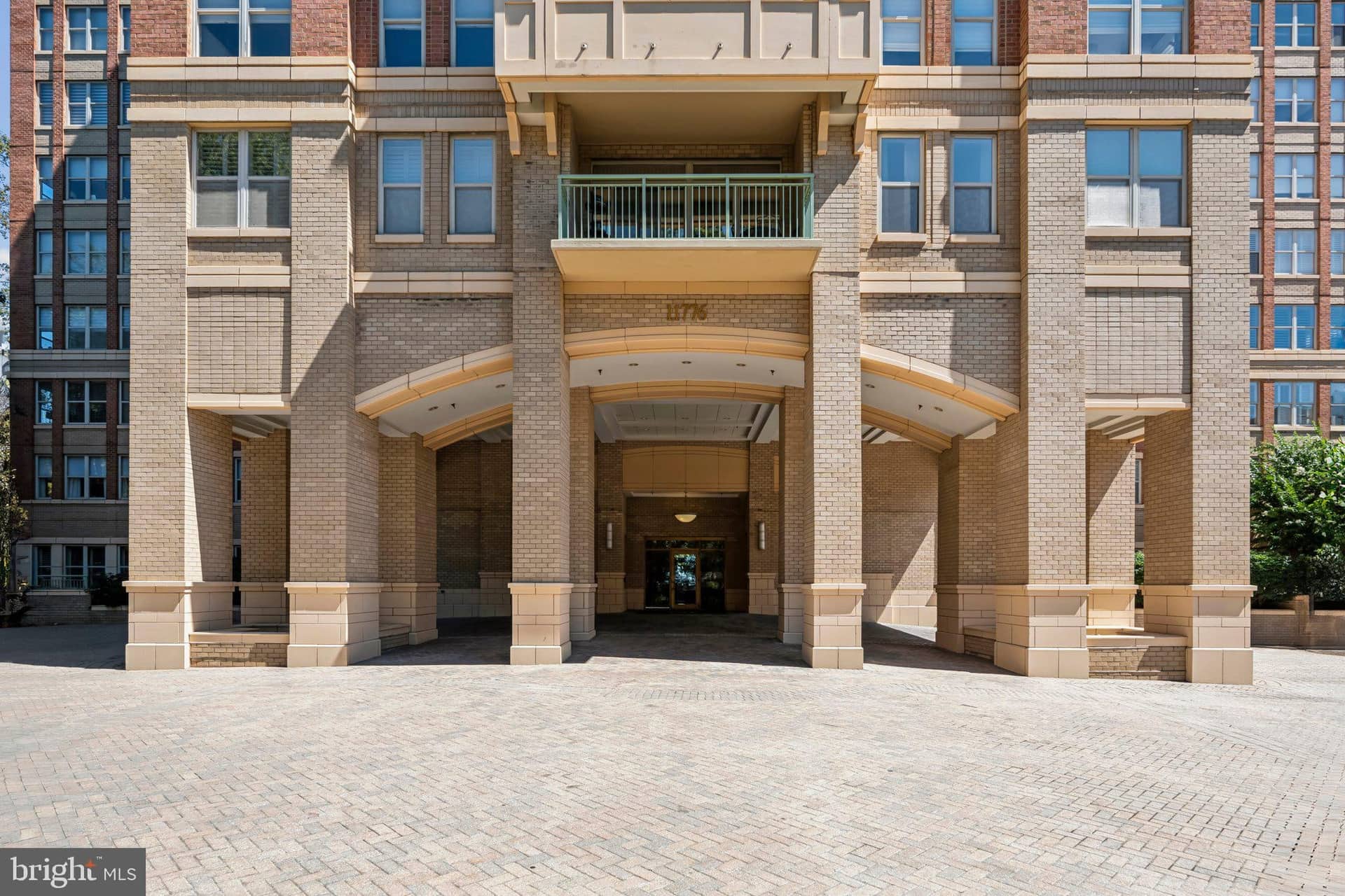 Covered porte-cochere entrance and brick-and-stone facade at Stratford House in Reston