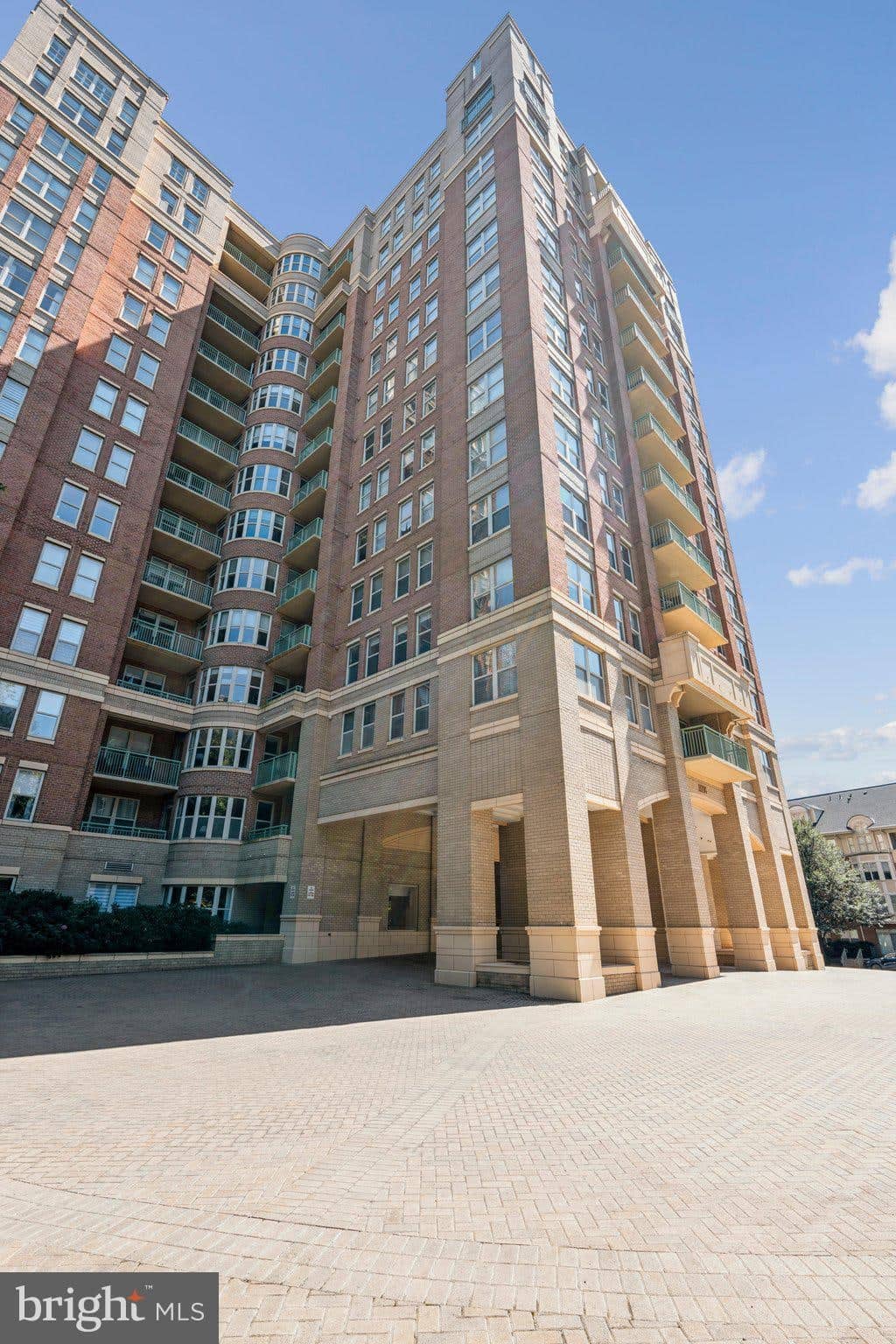 Upward view of the Stratford House high-rise tower and covered main entrance