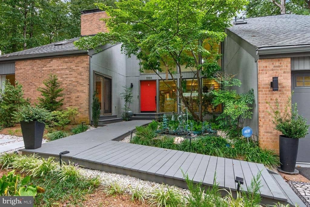 Red front door and landscaped entry courtyard at 2003 Upper Lake Drive