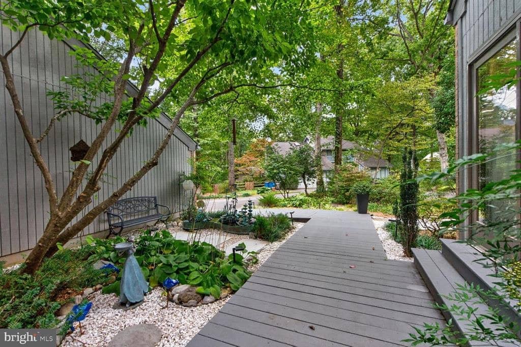 Entry walkway winding through mature landscaping at 2003 Upper Lake Drive