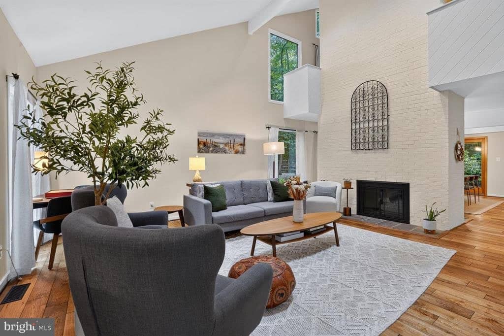 Living room seating beside the white brick fireplace at 2003 Upper Lake Drive