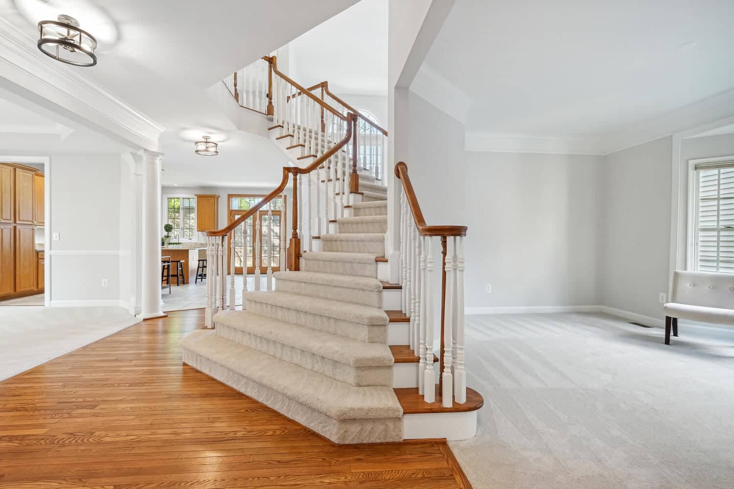 Grand foyer at 2608 Amanda Court with curved staircase, hardwood flooring, and openings to the formal rooms