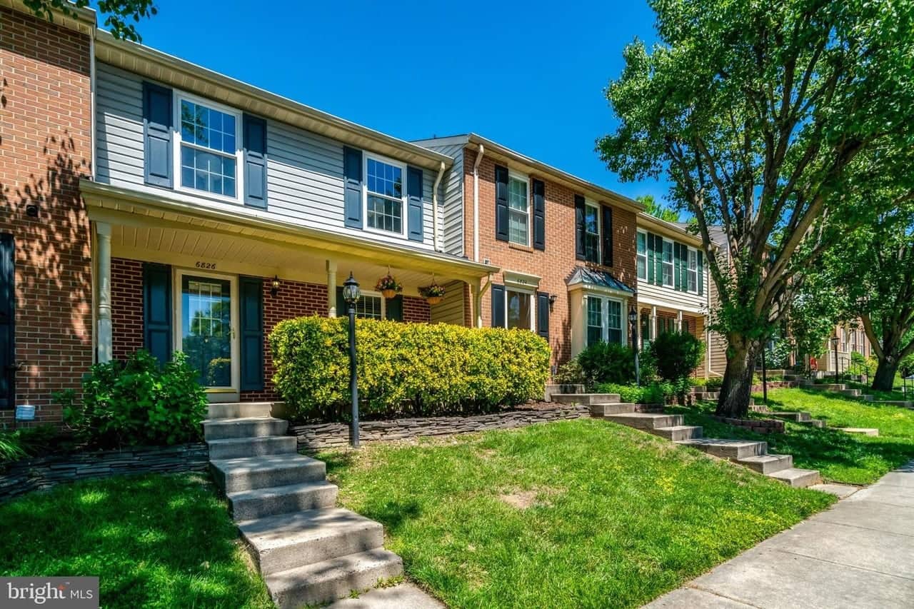 Streetscape view of 6826 Ericka Avenue and neighboring Manchester Lakes townhomes