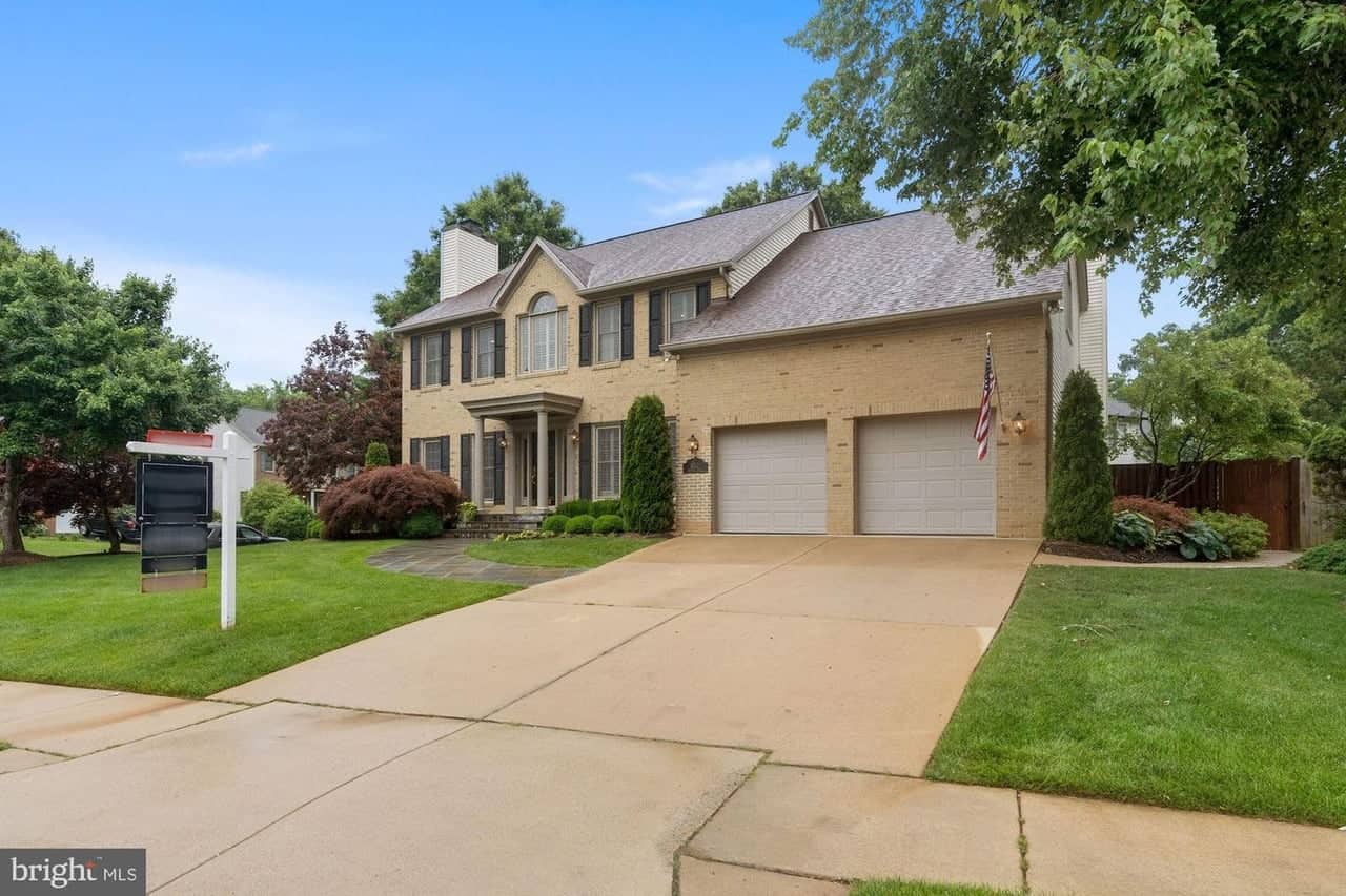 Angled front view of 8312 Rampart Court showing the driveway and attached garage