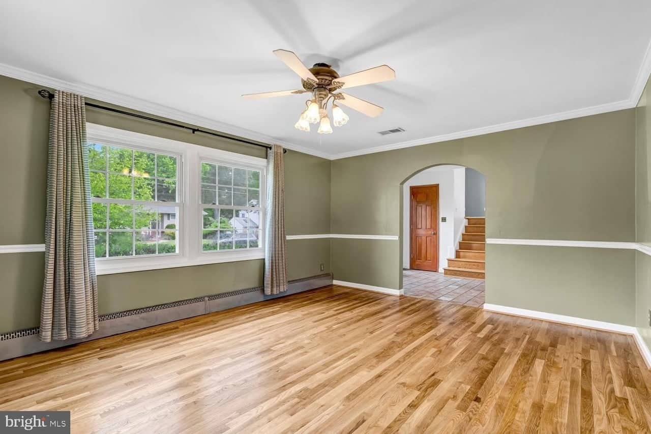 Second dining-room view with paired windows and the foyer beyond