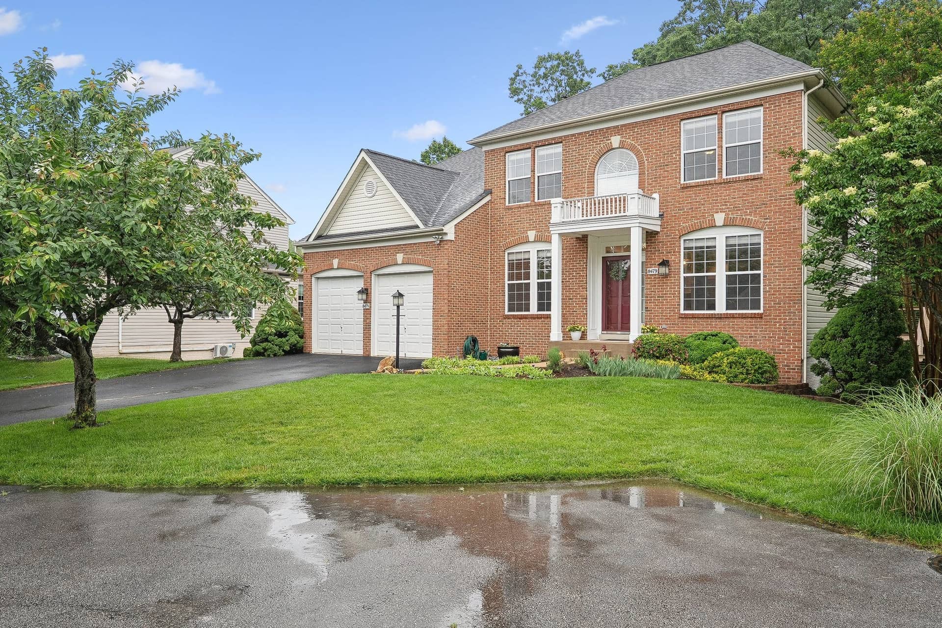 Wide front view of 8479 Catia Lane from the cul-de-sac with the driveway and mature landscaping