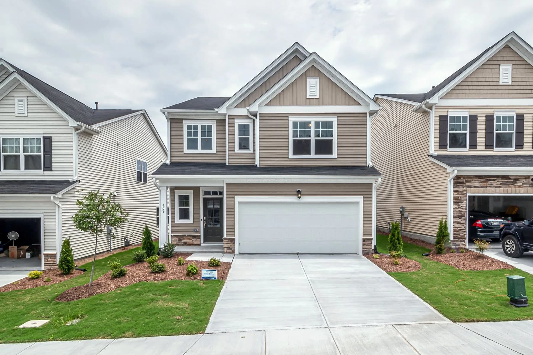 Attached townhomes with gabled roofs, garages, and small front gardens — architectural inspiration