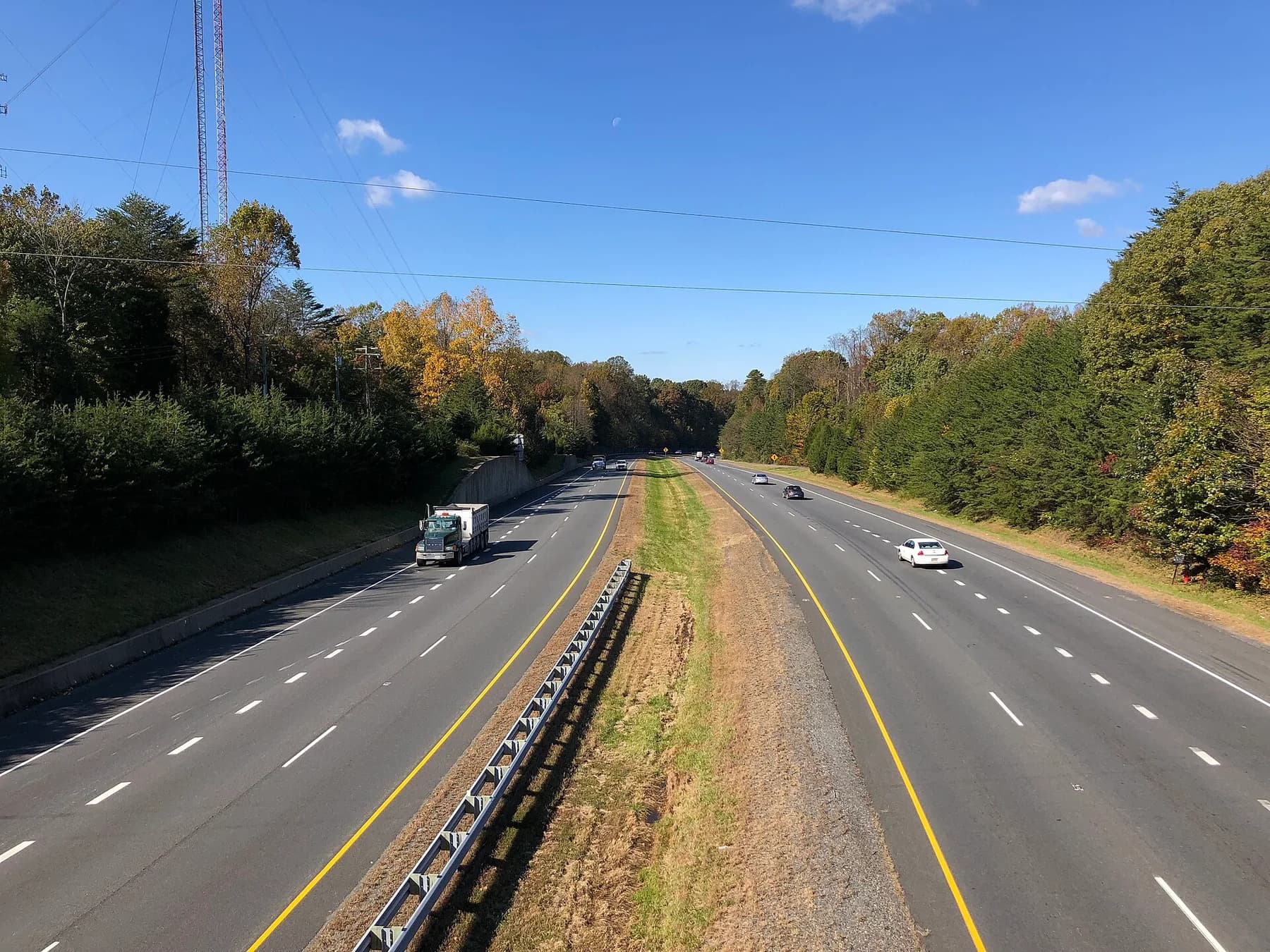 Fairfax County Parkway framed by autumn trees, viewed from Ox Road in Fairfax Station