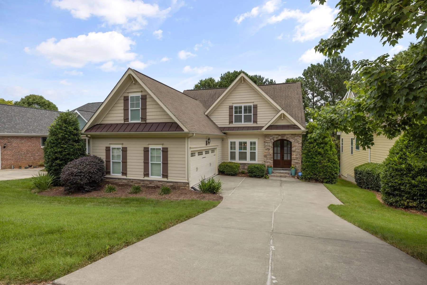 Traditional gabled suburban home with lawn and mature trees — architectural inspiration